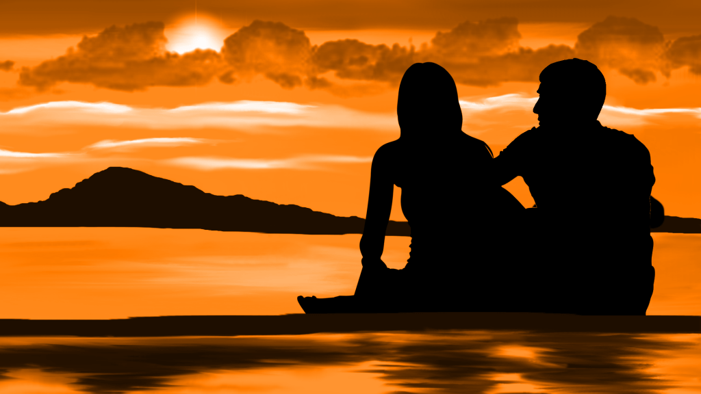 BeziehungsCoaching, ein Paar schaut am Strand in den Sonnenuntergang